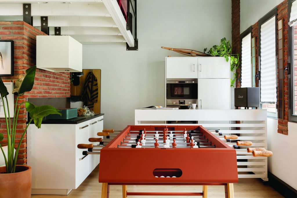 An indoor foosball table in a large room.