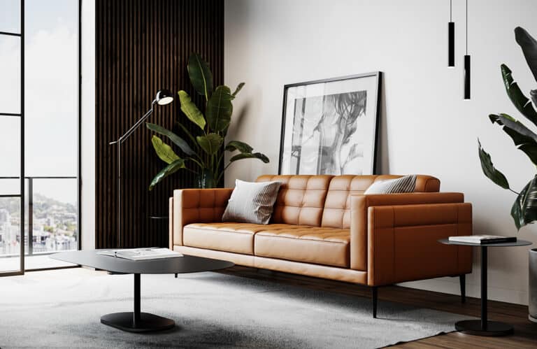 Modern living room with an orange tufted leather sofa, black coffee table, and framed artwork near a large window.