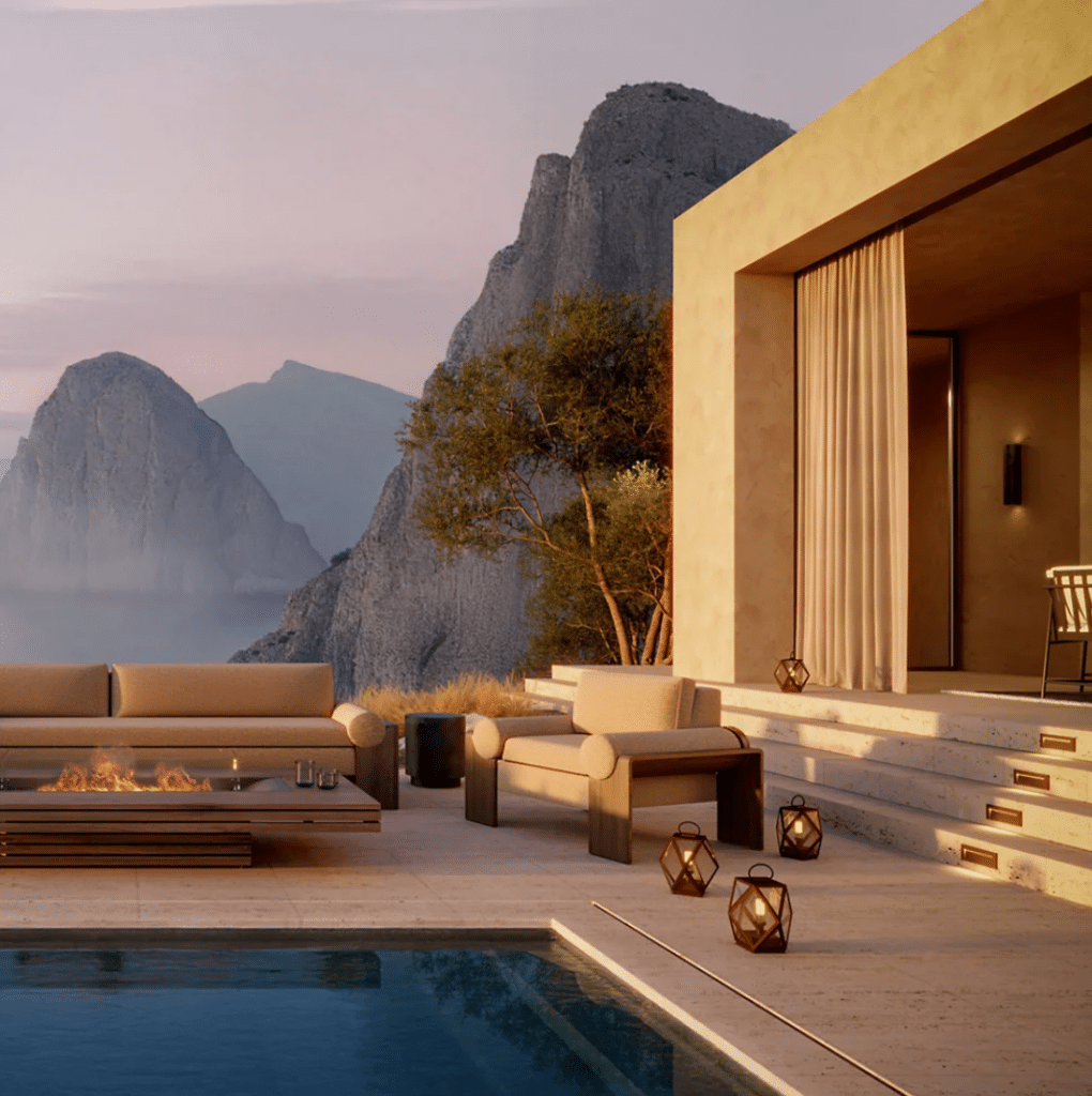 Modern outdoor lounge with beige seating around a rectangular fire pit, overlooking mountains and a swimming pool at sunset.